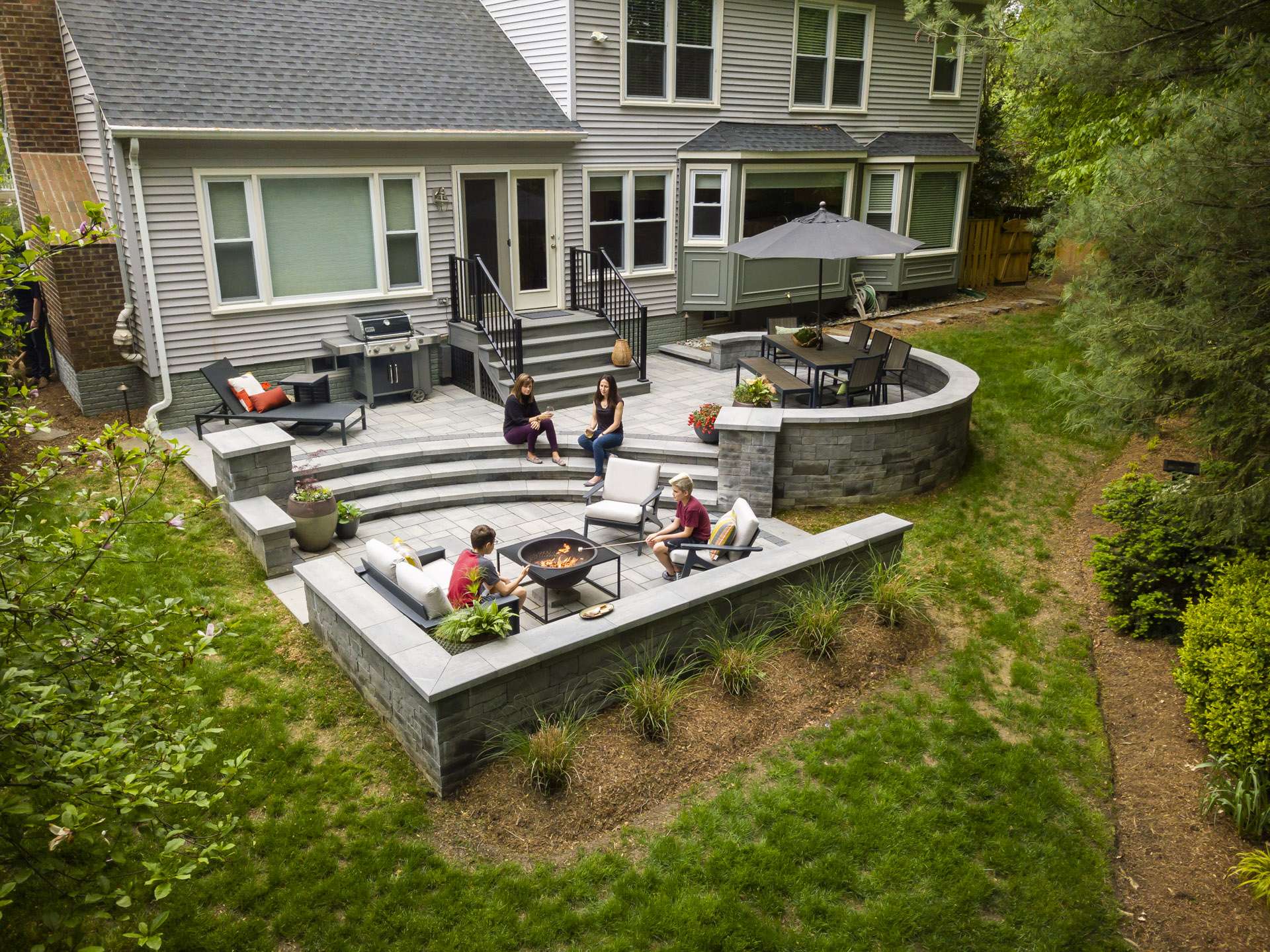 aerial-patio-fire-pit-wall-kids-customers-house