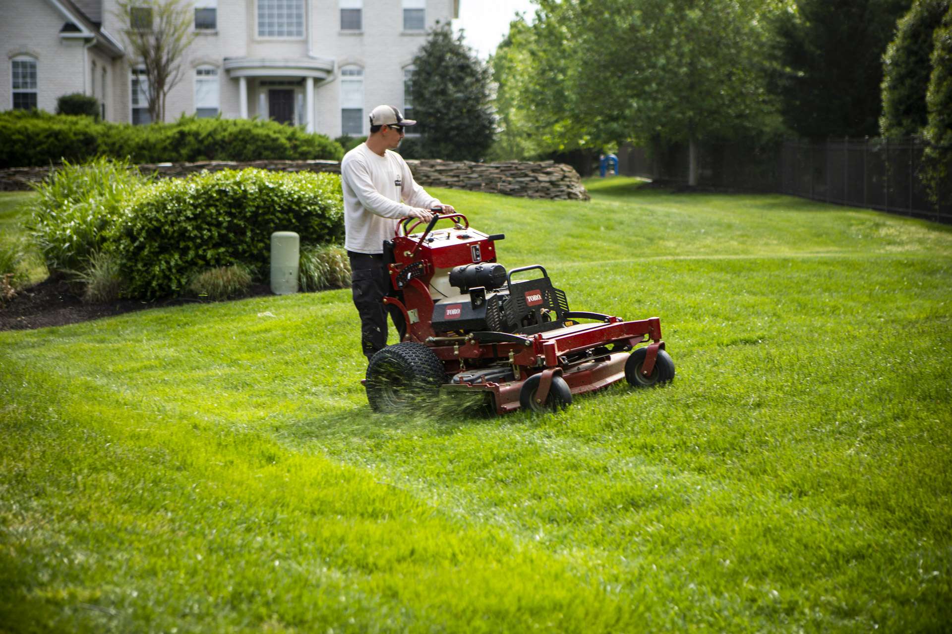 Lawn care technician mowing 