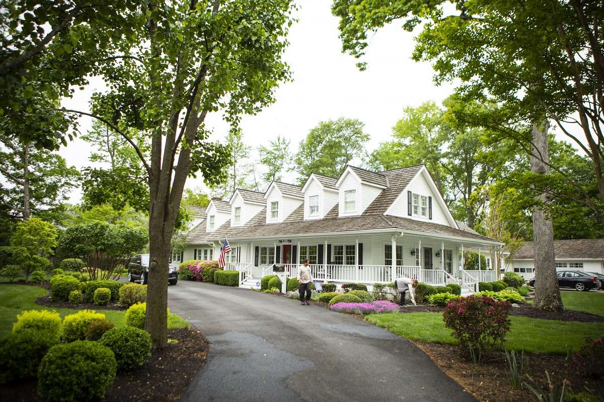 nice house with extensive planting beds full of shrubs perennials and trees