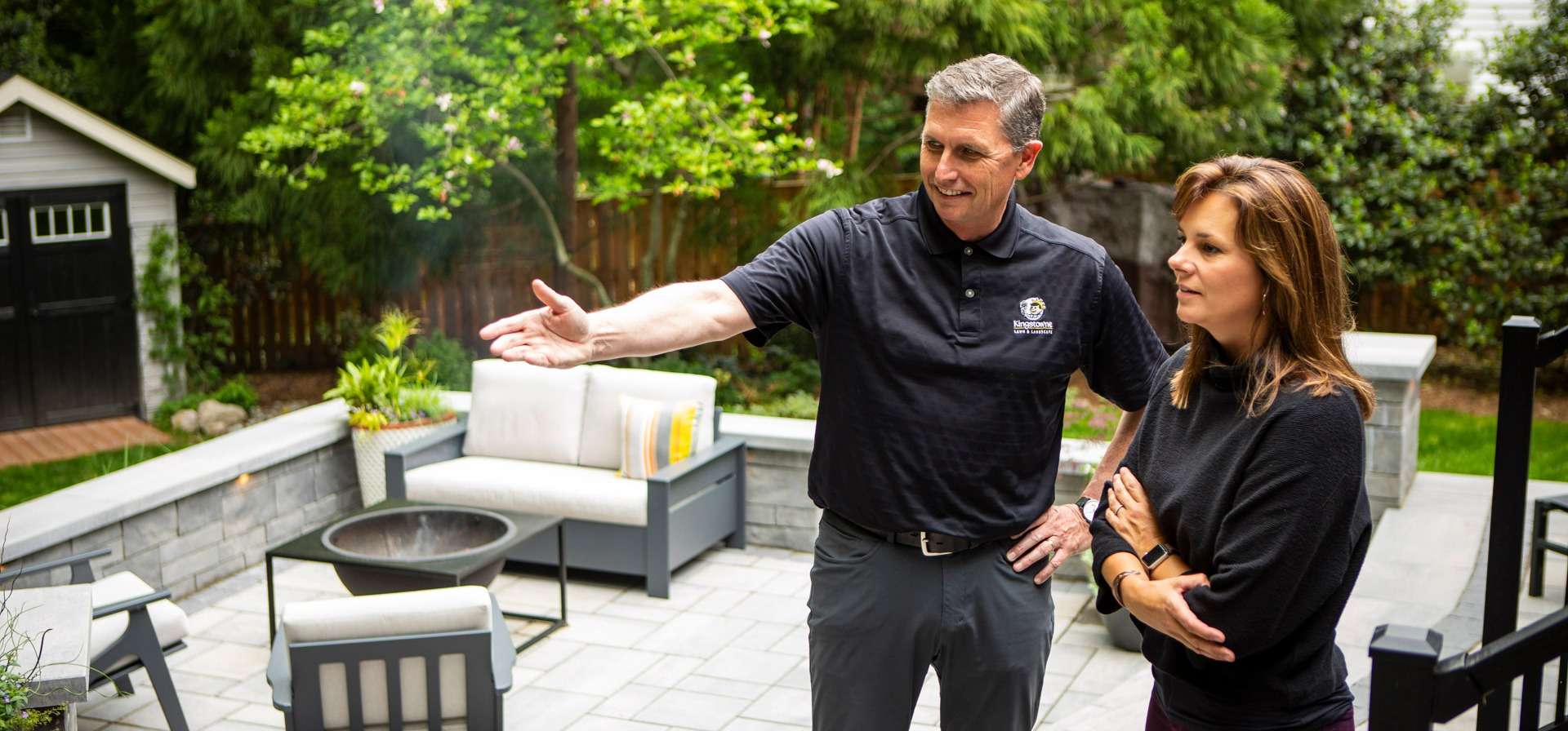 Landscaper standing on patio with customer