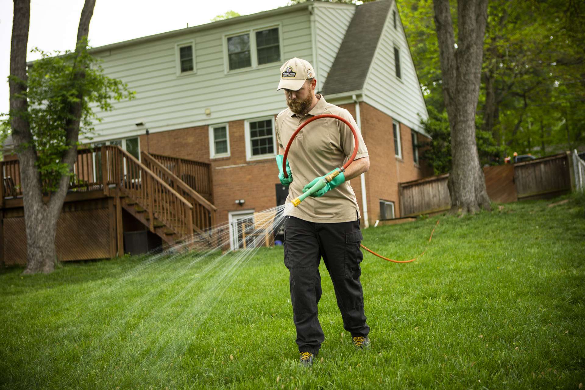 lawn technician spraying lawn to protect from lawn disease