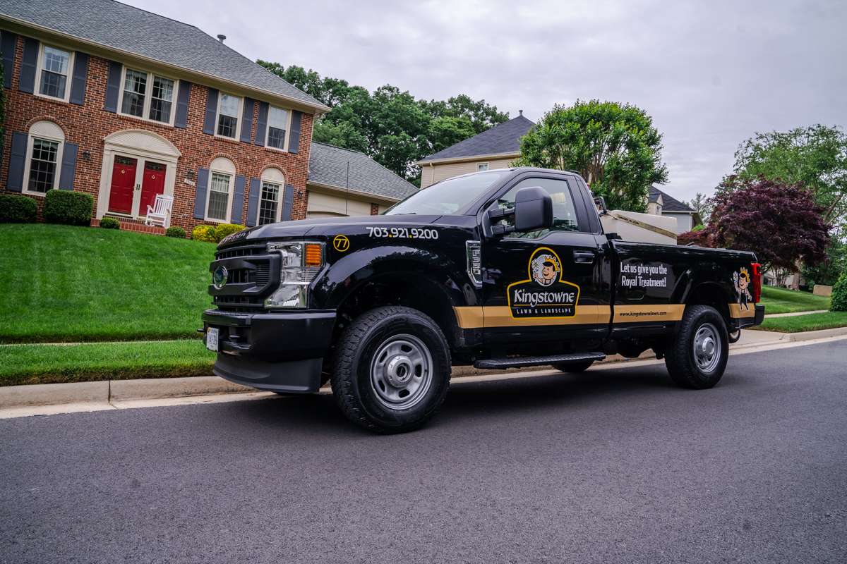 truck parked in front of healthy lawn