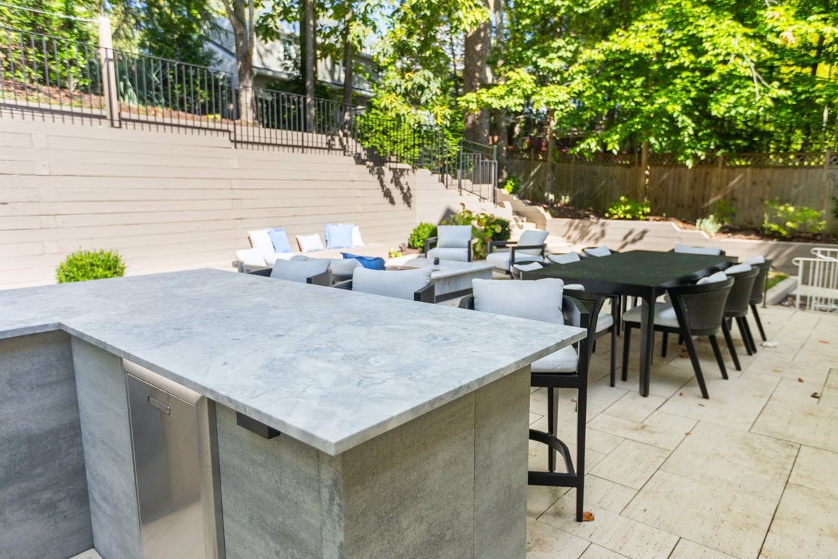 backyard hardscape outdoor kitchen patio furniture retaining wall shade trees