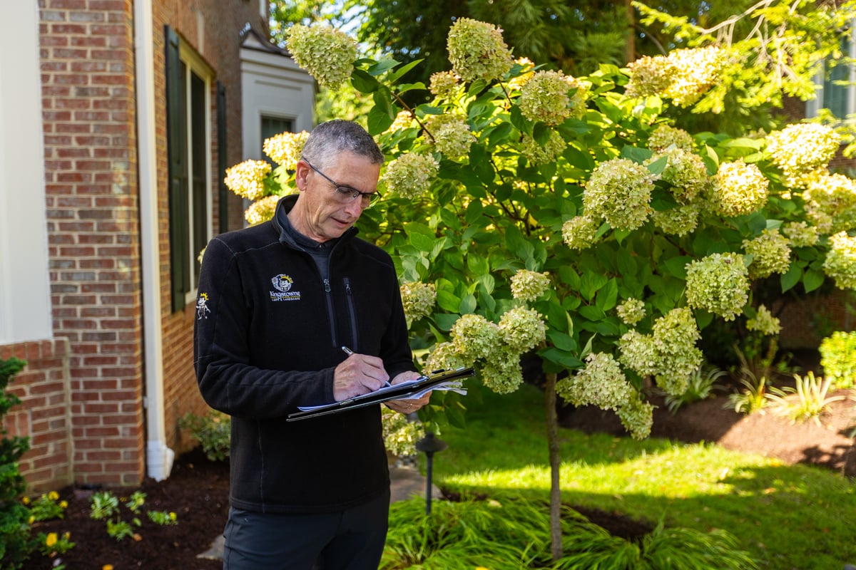 account manager landscape designer inspecting property 7