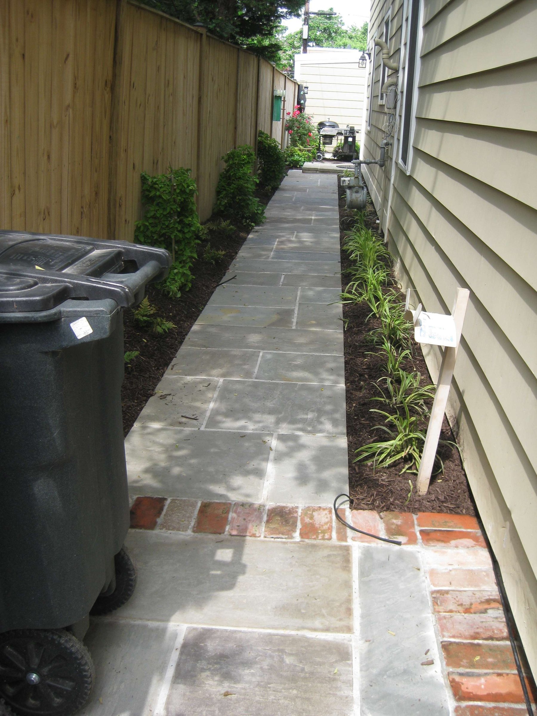 stone walkway along the side of the house