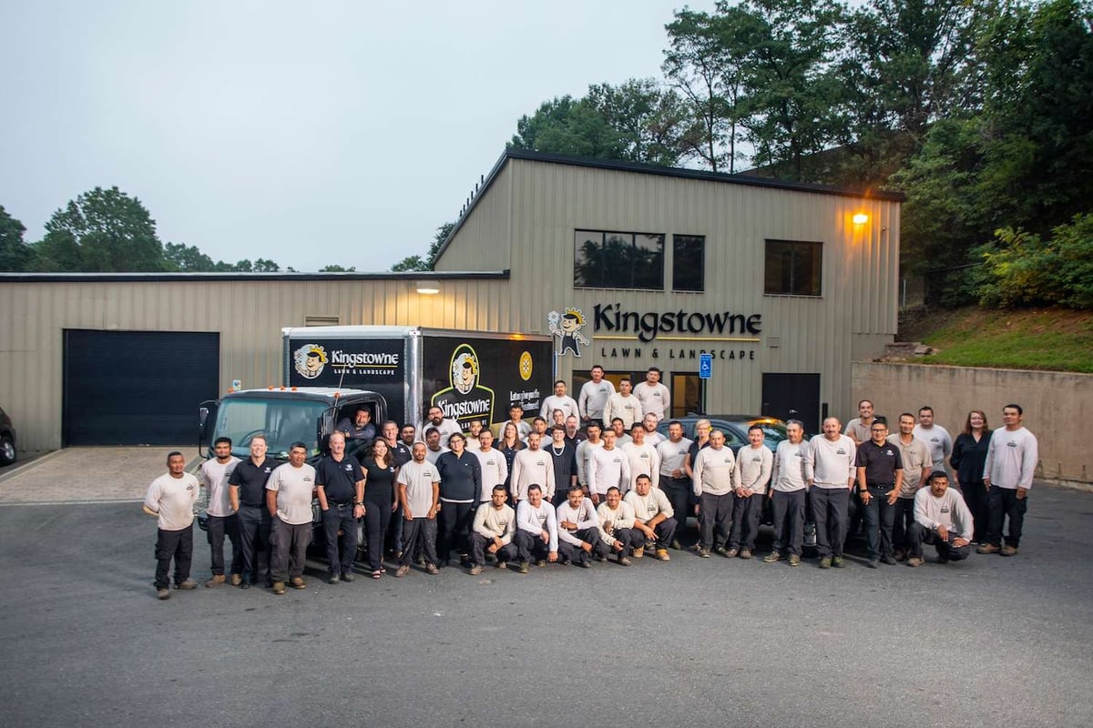 Kingstowne lawn and landscape team in front of building