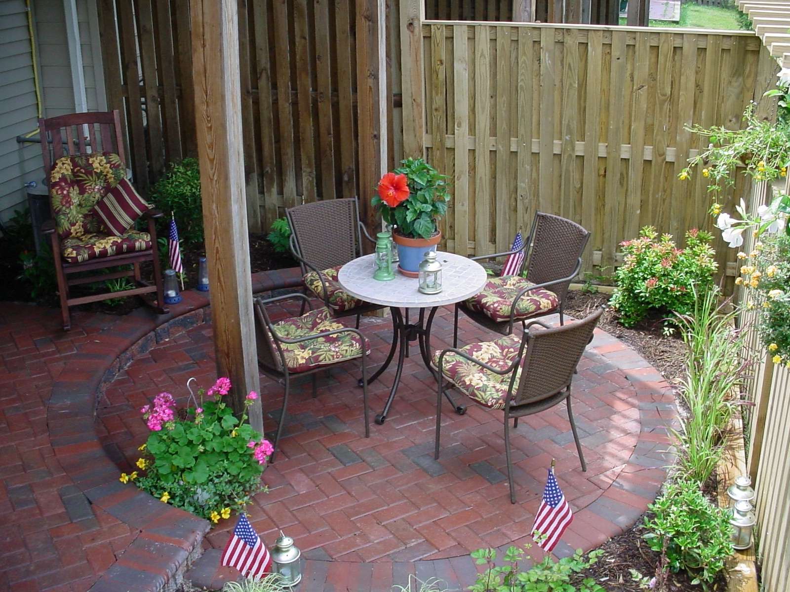 Enclosed townhouse patio with small plants and flowers