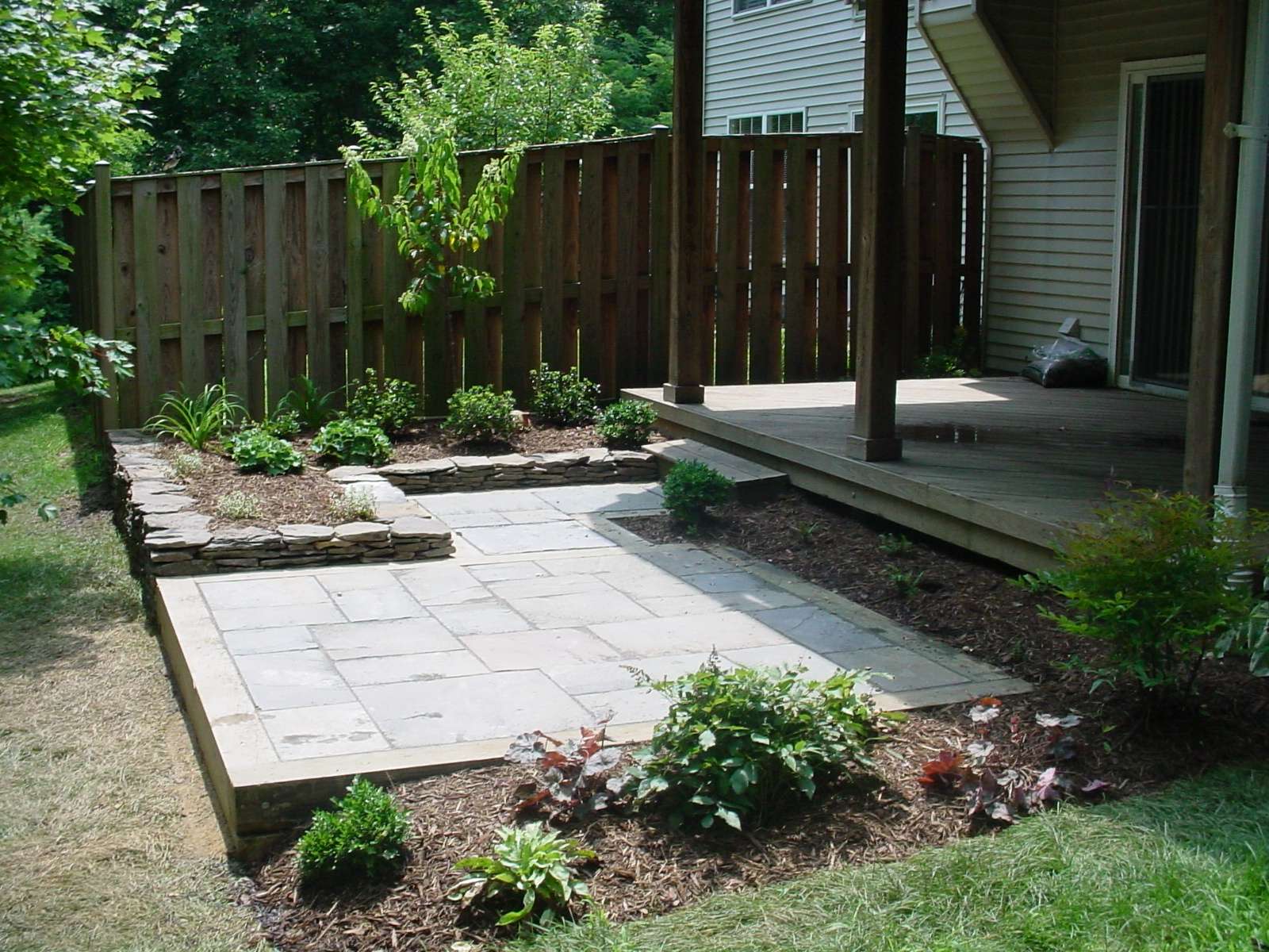 Townhouse backyard patio surrounded by greenery