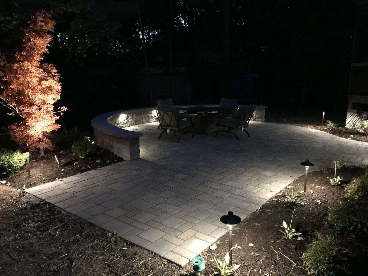 landscape lighting around patio and seat wall