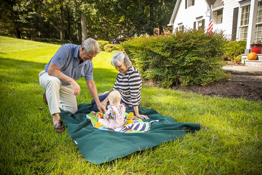 customers sit on healthy lawn with baby