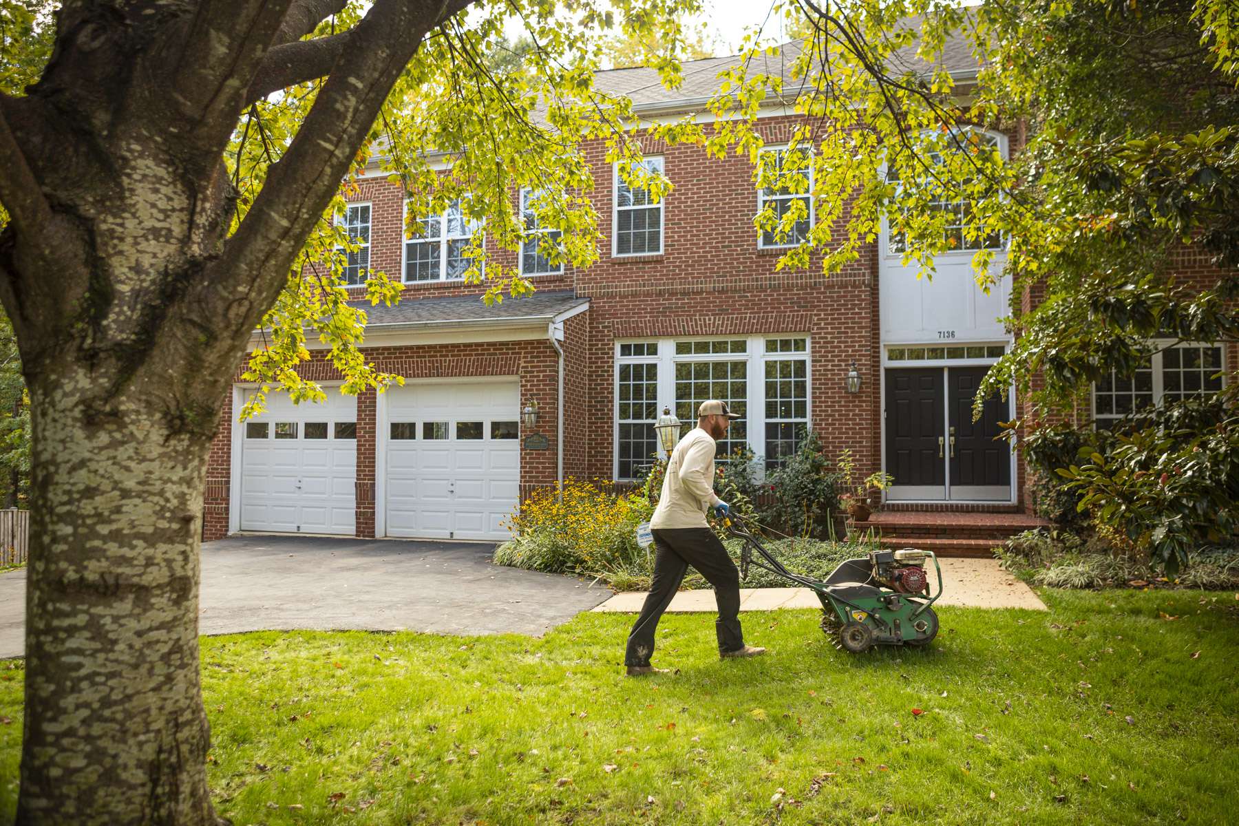 Lawn care technician aerating