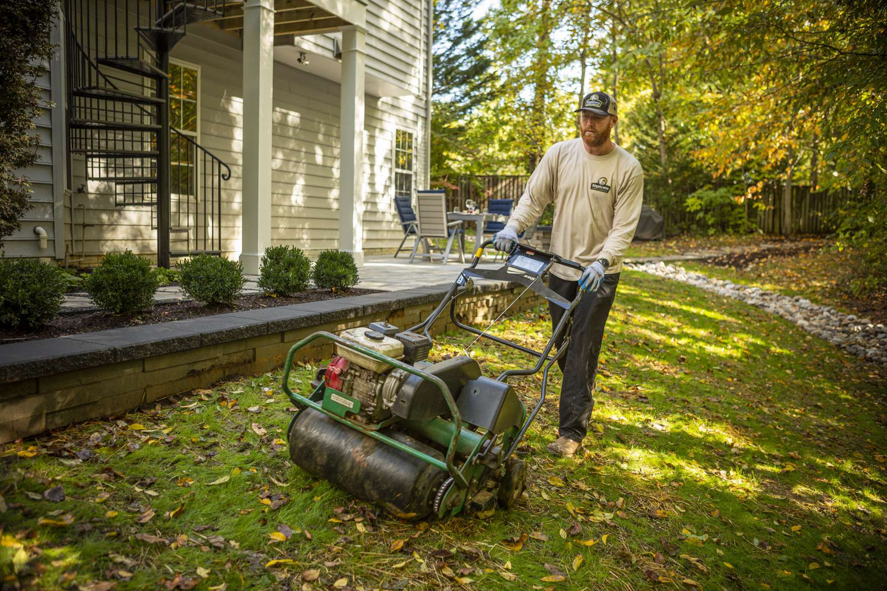 Kingstowne lawn technician aerating a lawn