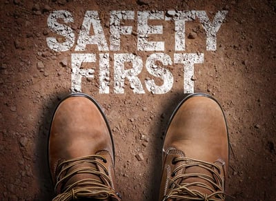 Boots and Safety First text on dirt