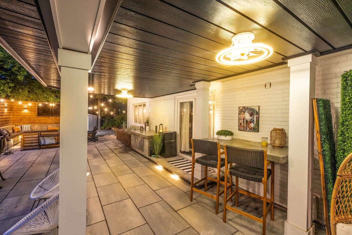 entertaining area below deck with outdoor kitchen and seating