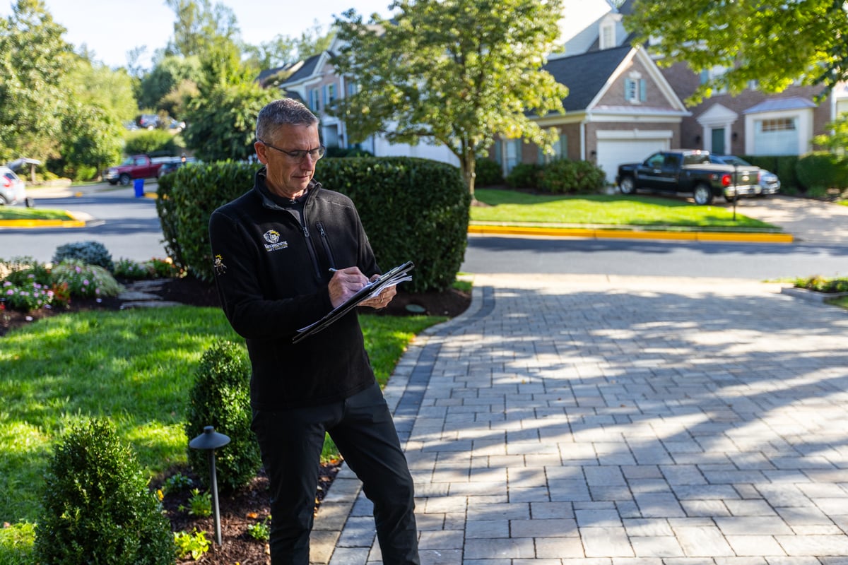 account manager landscape designer inspecting property 3