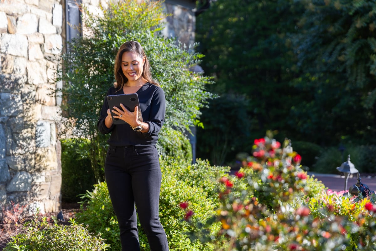 customer (spokesperson) walking through nice planting beds stone walkway foundation beds 14