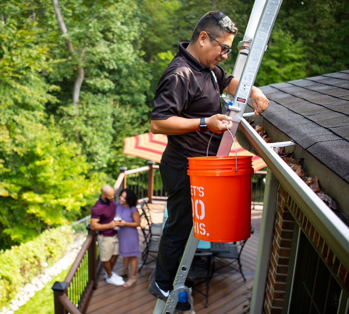 landscape maintenance team cleans gutters