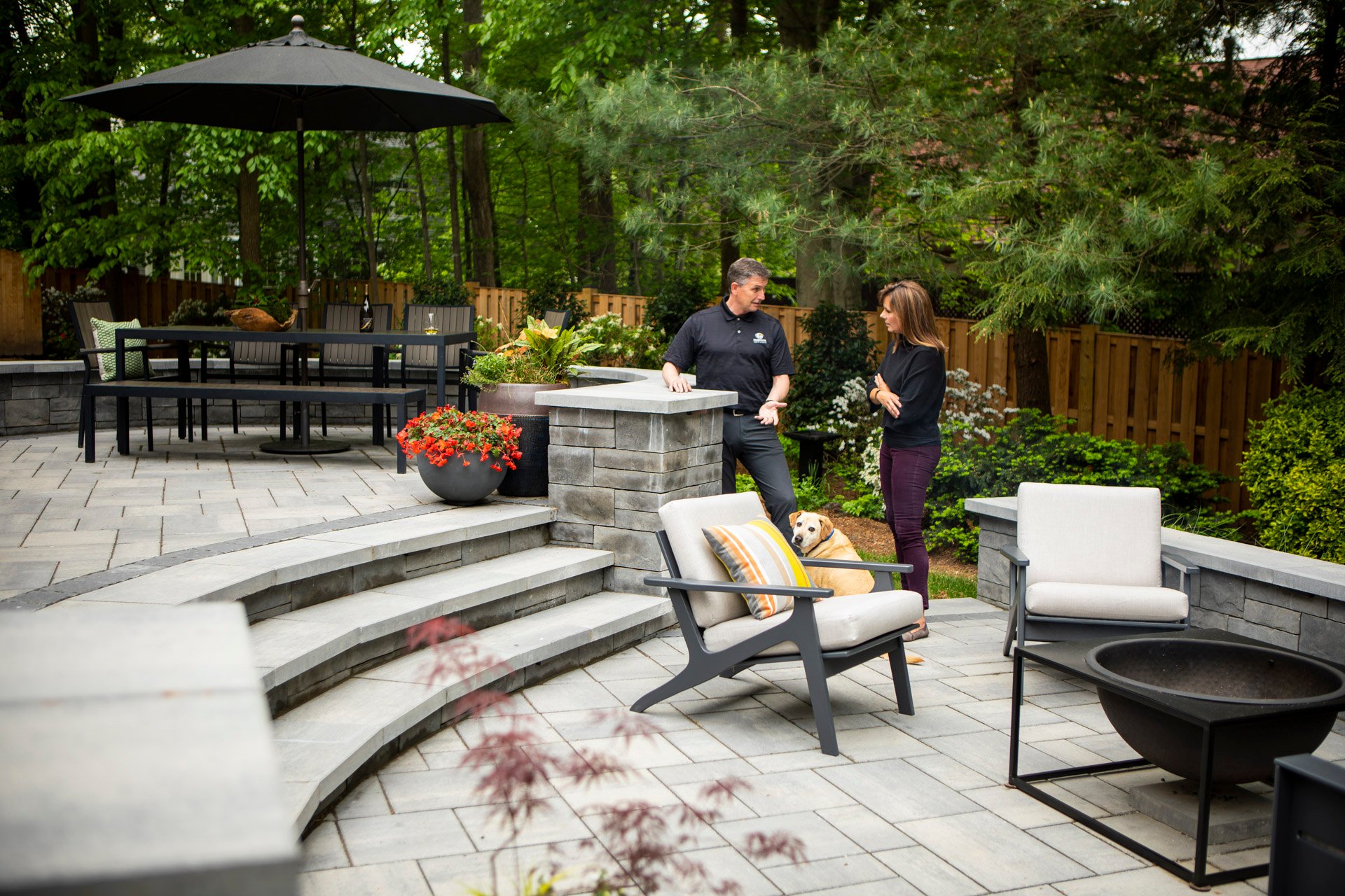 landscape designer and customer reviewing a paver patio project