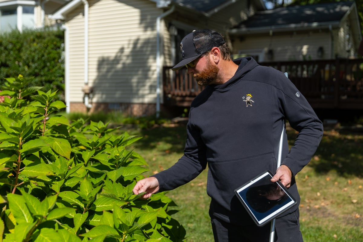maintenance account manager takeoff measuring wheel reviewing lawn inspecting landscape 3