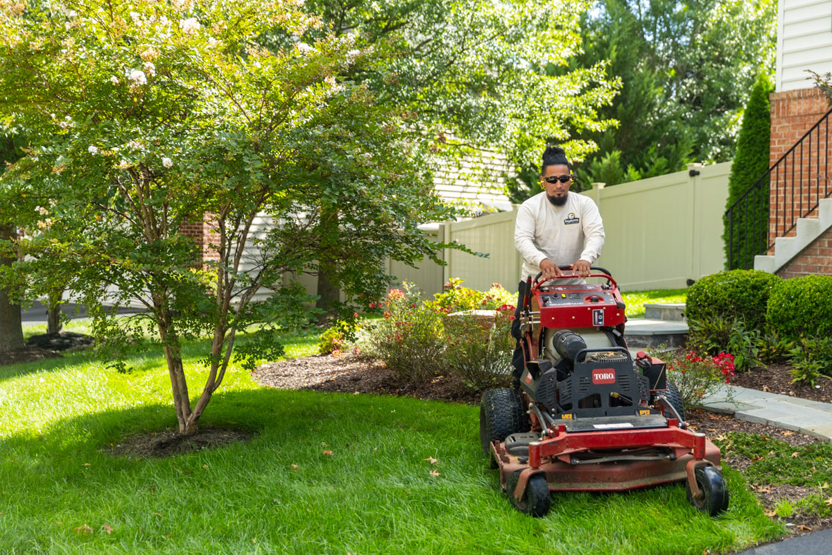 maintenance crew mowing lawn fence backyard fall 4