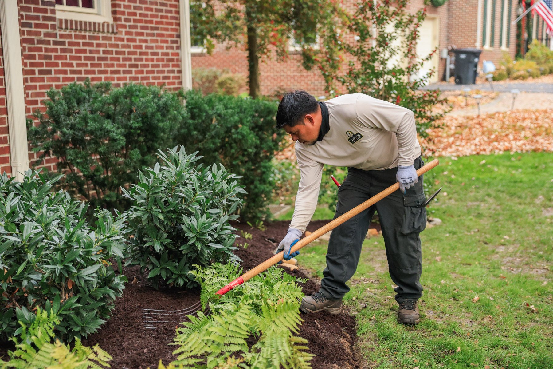 maintenance team planting bed raking fall cleanup