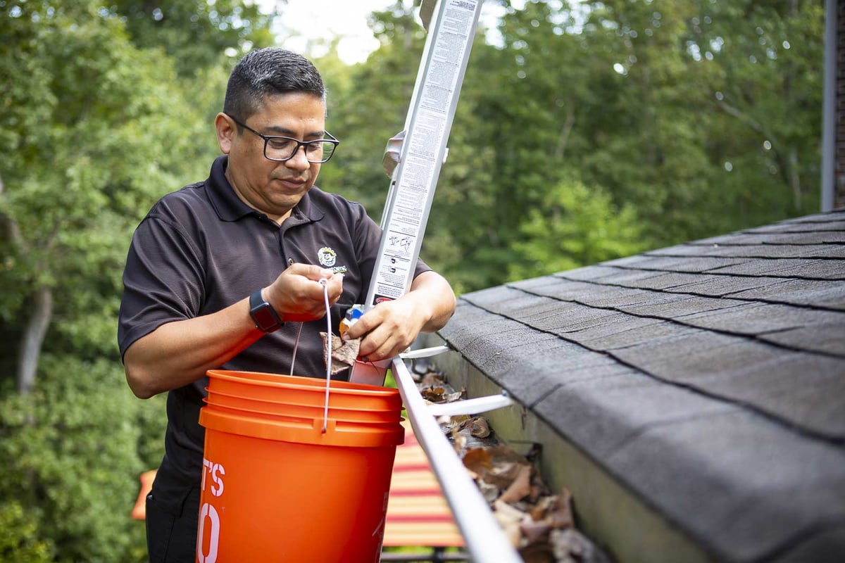 landscape team cleaning out gutters