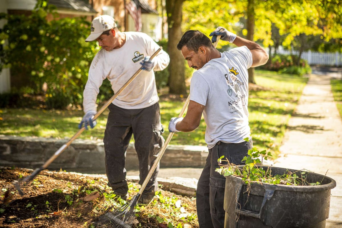 landscape maintenance team clean up landscape beds in spring