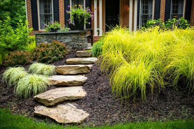 plant bed and rock steps with mulch installed by Kingstowne Lawn & Landscape