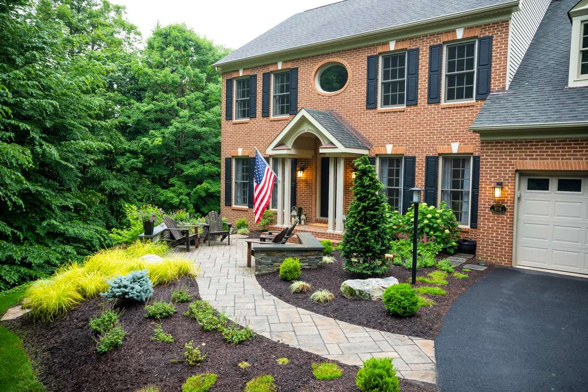 entrance to home with plantings and paver walkway