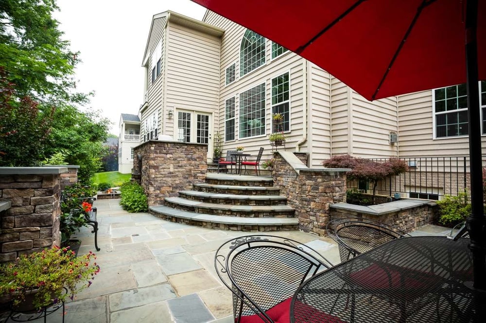 patio with steps, walls, and pond