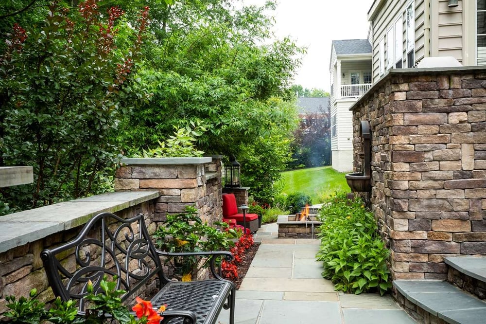 patio with bench, retaining walls, and fire pit