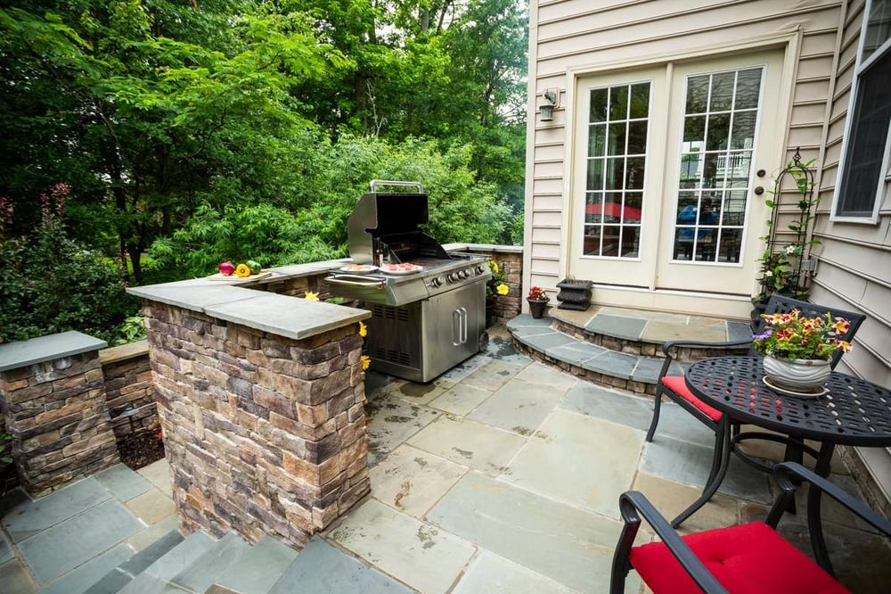 Patio in Alexandria, VA with grill, walls, and steps