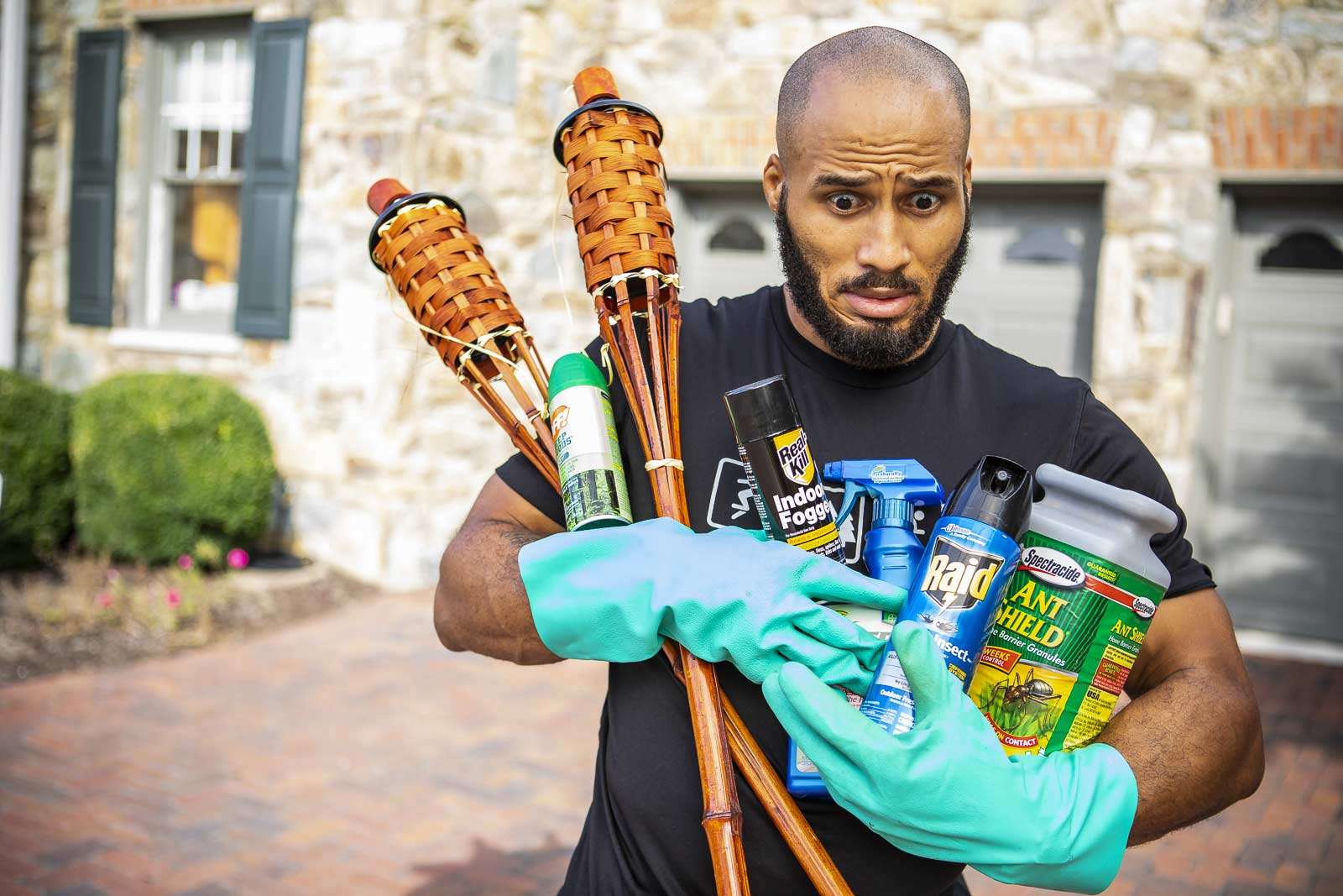 homeowner carries diy pest control products