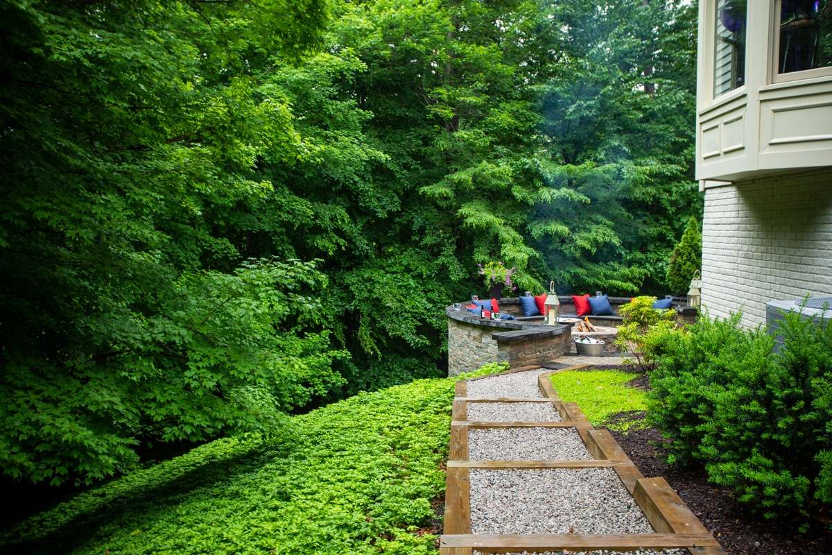 ground cover on slope with walkway and firepit with seating area