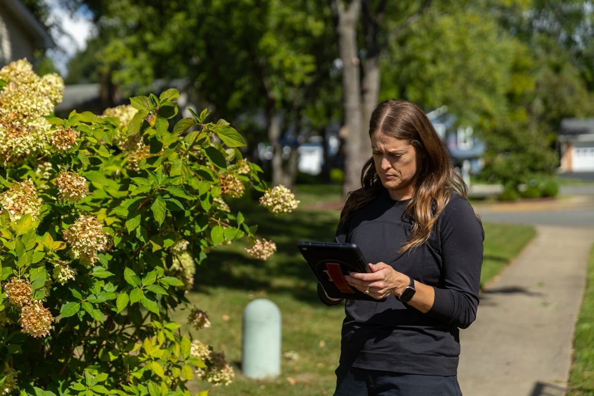 landscape designer inspecting a northern virginia garden during a design consultation