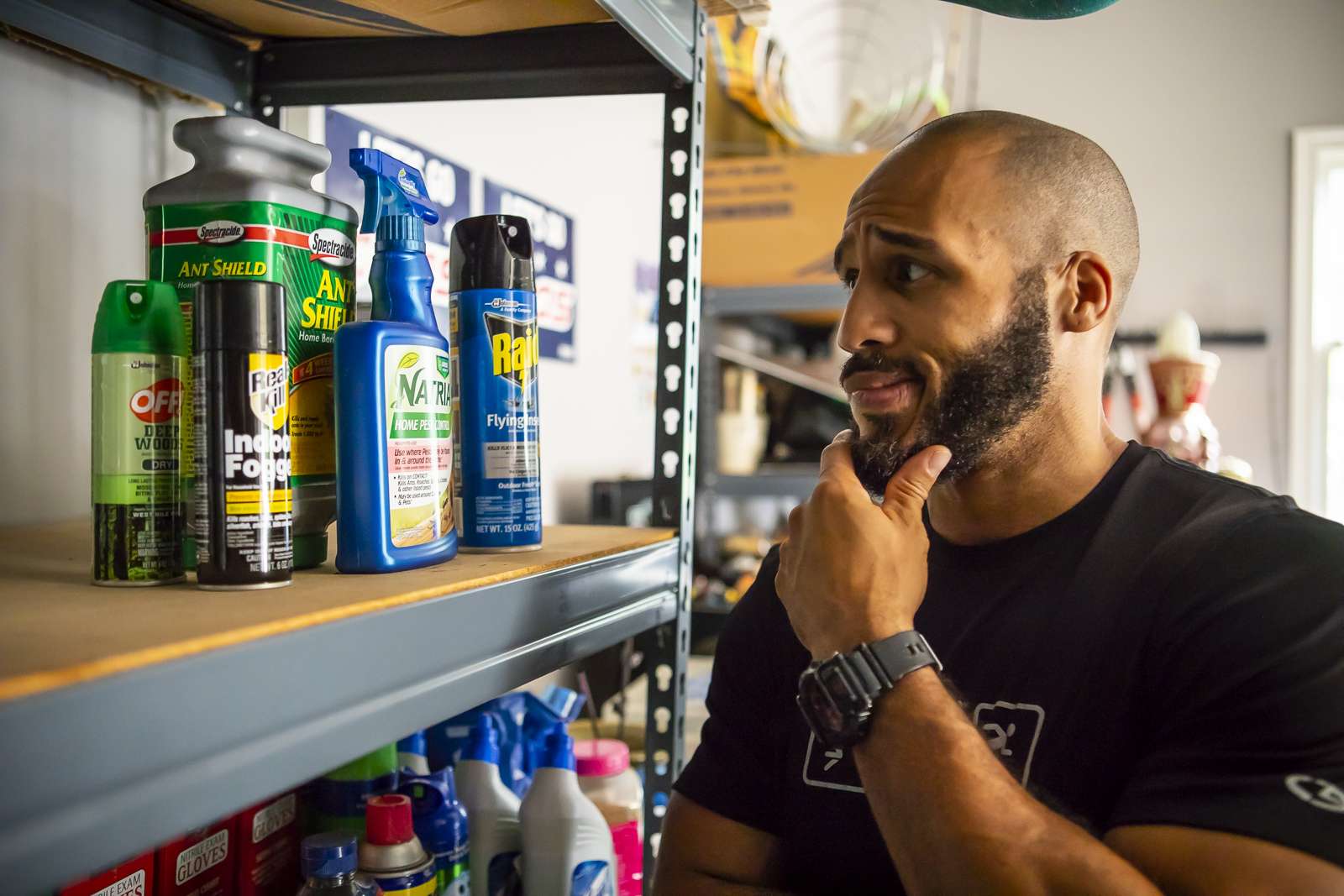 homeowner looks at outdoor pest products on shelf