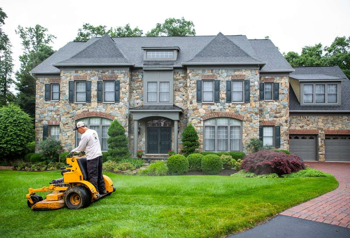 Technician performing lawn mowing  services